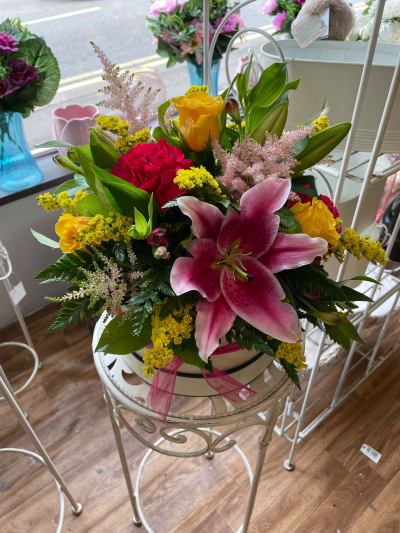 Raspberry Sunshine Hat Box - A vibrant hat box arrangement bursting with rich pink and sunny yellow tones, perfect for birthdays, congratulations or thank yous, handcrafted by Pursehouse Florist in Cannock.