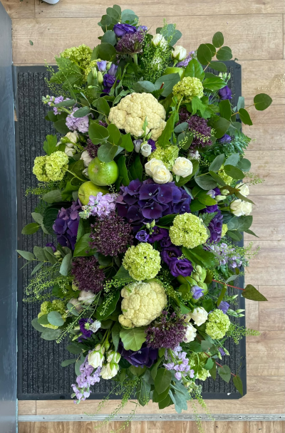 Purple & Green Casket Spray - A distinctive casket spray combining beautiful flowers, foliage and natural fruit and vegetable details, handcrafted by Pursehouse Florist in Cannock.
