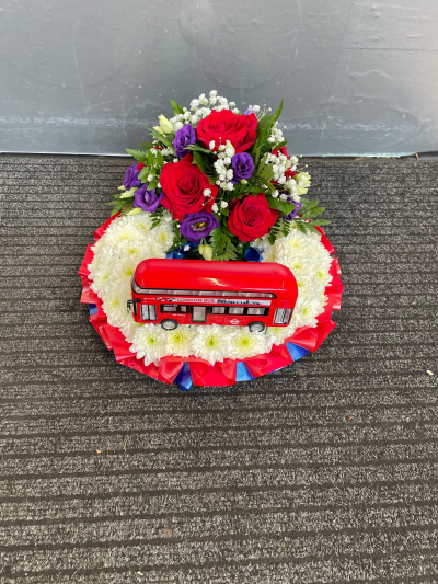 London Bus Cushion Tribute - A personalised funeral cushion featuring a classic London bus, handcrafted in red, white and blue by Pursehouse Florist in Cannock.