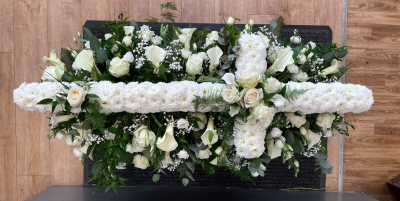 White Cross Casket Tribute - An elegant white casket spray featuring a traditional floral cross, handcrafted with care by Pursehouse Florist in Cannock for a meaningful farewell.