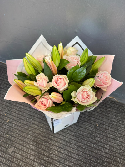 Pink Lily Rose - An elegant arrangement showcasing delicate shades of blush pink and soft pastel tones, beautifully complemented by fresh greenery. Presented in a stylish gift bag, this romantic design is perfect for celebrating anniversaries, birthdays, welcoming a new baby or surprising someone special.