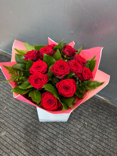 12 Red Roses - A timeless expression of love, this stunning arrangement of rich, romantic red roses complemented by lush greenery. Beautifully presented in a stylish gift bag, it's the perfect choice for anniversaries, Valentine's Day or simply reminding someone special how much they mean to you.