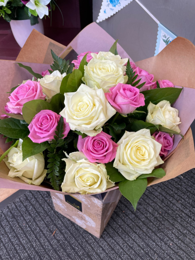 Sweet Romance - A gorgeous combination of soft pink and creamy ivory tones, thoughtfully arranged with fresh greenery to create a beautifully romantic display. Presented in a stylish gift bag, this elegant design is perfect for anniversaries, birthdays, engagements or simply showing someone how much you care.