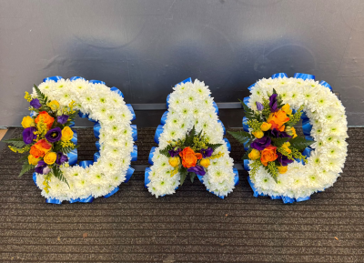 DAD - A beautiful personalised DAD funeral tribute featuring a traditional white floral base, vibrant yellow, orange and purple accents and elegant blue ribbon edging. Lovingly created to honour a much-loved dad, this colourful arrangement is a heartfelt expression of love, gratitude and all the wonderful memories that will be treasured forever.