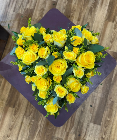 Golden Heart - A stunning open-style heart tribute created with beautiful yellow roses and complemented by lush greenery. This vibrant arrangement is a touching expression of everlasting love, friendship and treasured memories, providing a beautiful final farewell to someone dearly loved.
